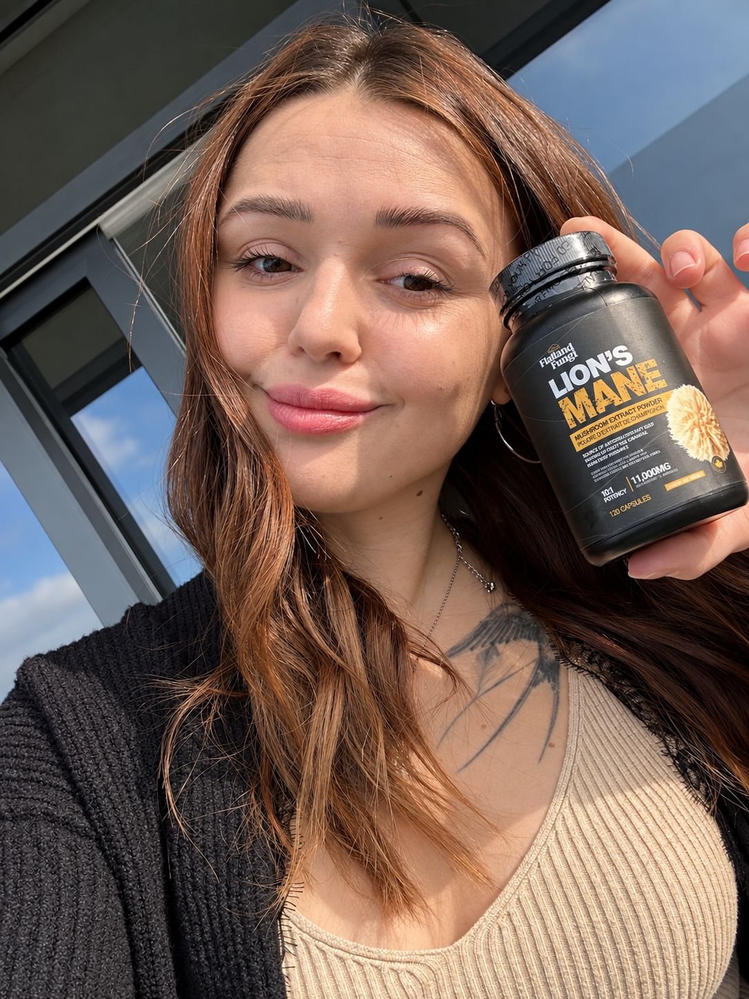Anastasiia holding a bottle of Flatland Fungi Lion's Mane capsules
